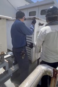 岐阜市の施設で自家発電機を点検。冷却水ヒーターや始動用蓄電池を確認する消防設備士。